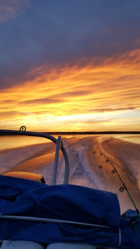 A fisherman enjoys a sunset on Lake Amistad.